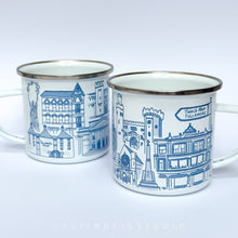 Load image into Gallery viewer, An enamel mug featuring detailed illustrations of various buildings and landmarks in Tullamore, including the Tullamore Dew Distillery and Charleville Castle. The mug has a white enamel finish with a silver rim. It is designed, illustrated, and hand-printed in Offaly. The mug is lightweight yet sturdy, making it ideal for camping, picnics, or enjoying a cosy morning at home. Each mug is hand printed and packaged in plastic-free and recyclable materials.