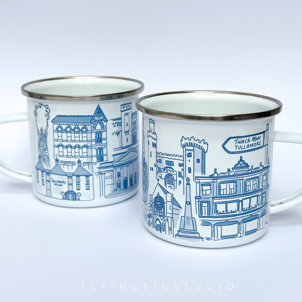 An enamel mug featuring detailed illustrations of various buildings and landmarks in Tullamore, including the Tullamore Dew Distillery and Charleville Castle. The mug has a white enamel finish with a silver rim. It is designed, illustrated, and hand-printed in Offaly. The mug is lightweight yet sturdy, making it ideal for camping, picnics, or enjoying a cosy morning at home. Each mug is hand printed and packaged in plastic-free and recyclable materials.