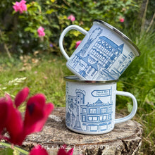 Load image into Gallery viewer, An enamel mug featuring detailed illustrations of various buildings and landmarks in Tullamore, including the Tullamore Dew Distillery and Charleville Castle. The mug has a white enamel finish with a silver rim. It is designed, illustrated, and hand-printed in Offaly. The mug is lightweight yet sturdy, making it ideal for camping, picnics, or enjoying a cosy morning at home. Each mug is hand printed and packaged in plastic-free and recyclable materials.